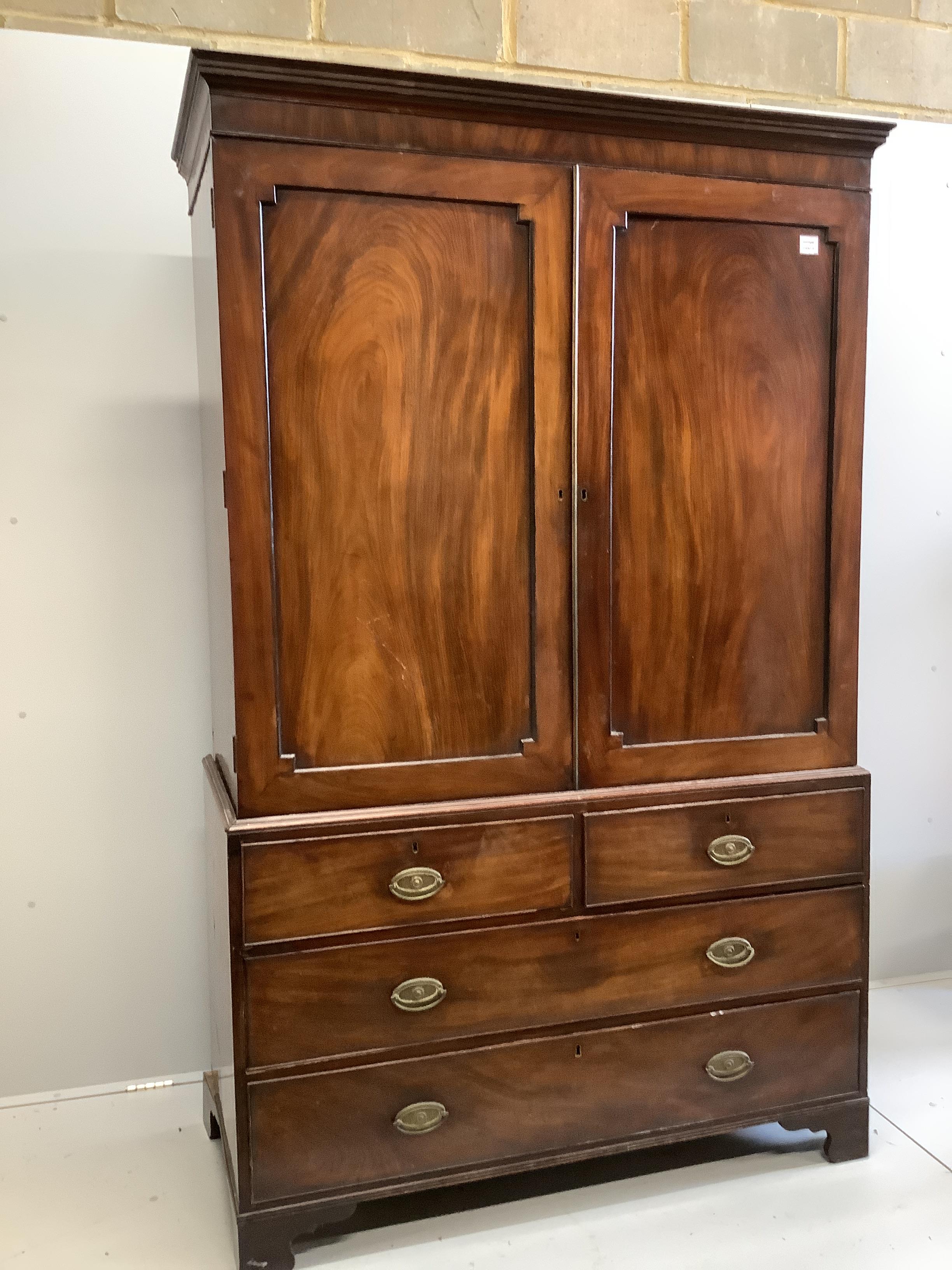 A George III mahogany linen press, converted to a hanging wardrobe, width 129cm, depth 58cm, height 206cm